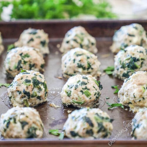 Side view of spinach turkey feta meatballs on a sheet pan after baked.