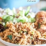 a plate full of french onion soup rice with a salad in the background.