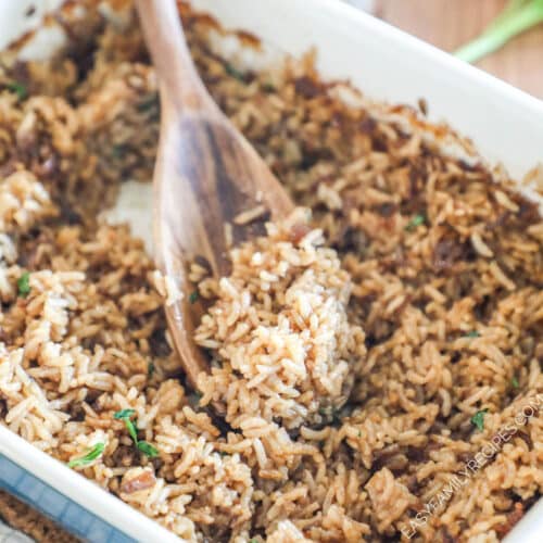 above image of a rice dish with french onion soup in a baking dish with a wooden spoon.