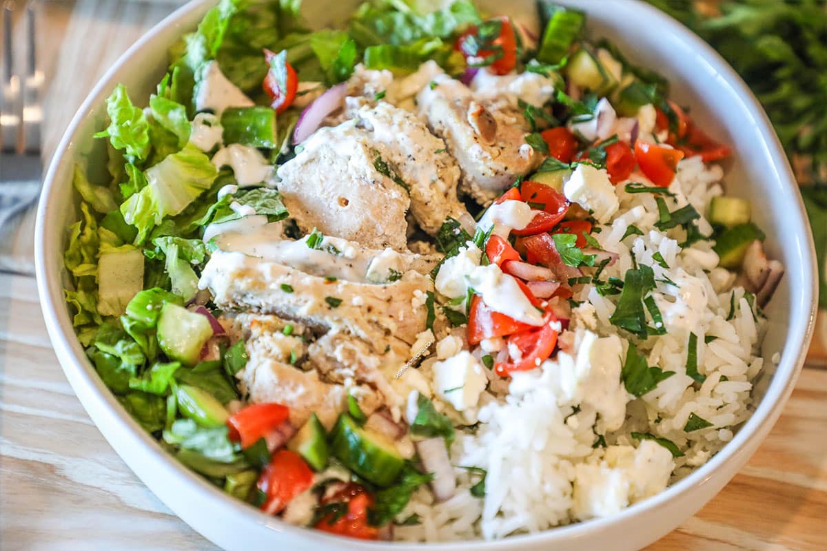 Close up of plated chicken gyro bowl in a white bowl