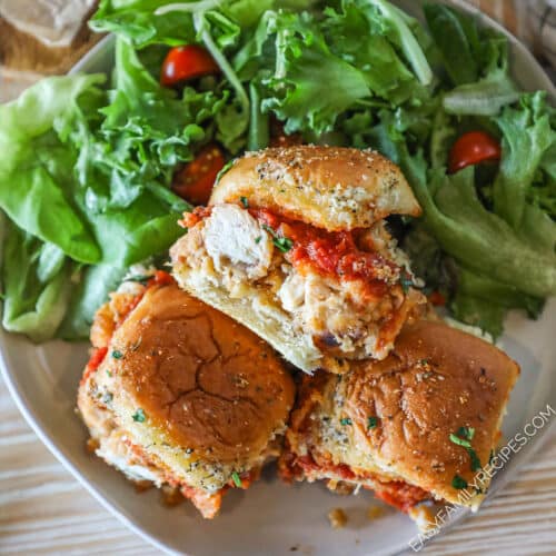 3 ready to eat Parmesan Chicken Sliders on a white plate