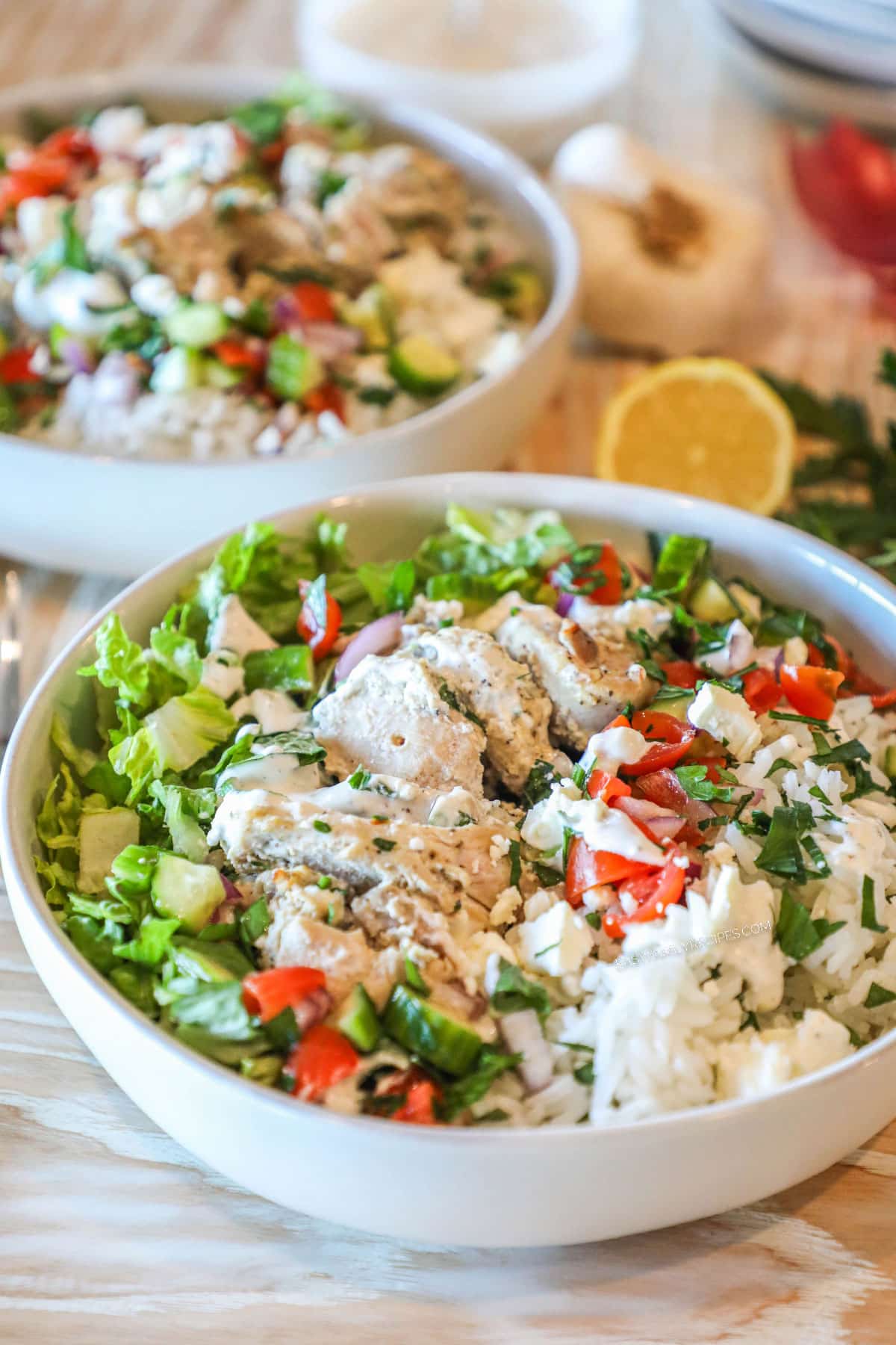 2 Chicken Gyro Bowl with toppings in white bowls