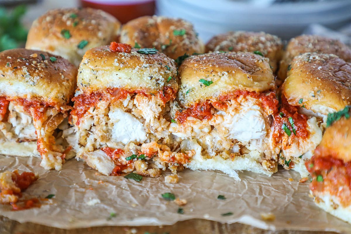 chicken parmesan sliders that are oozing marinara and ready to eat