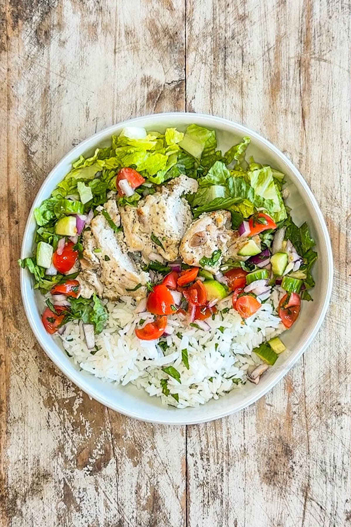 Chicken Gyro Bowl with toppings in a white bowl