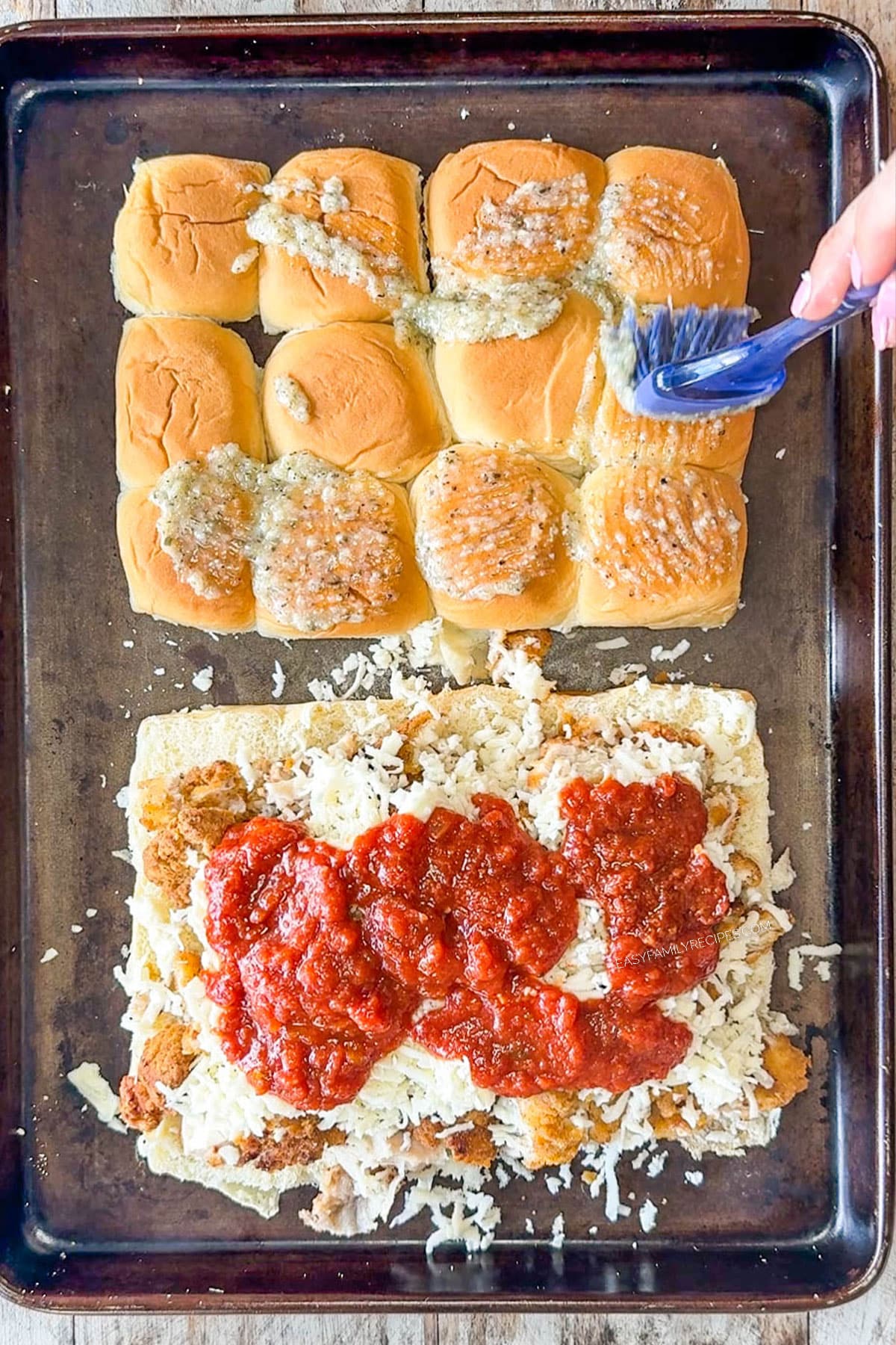 Use the cheesy butter mixture to brush the tops of the slider buns. Then, spoon the marinara sauce over the chicken and sprinkle cheese on top.