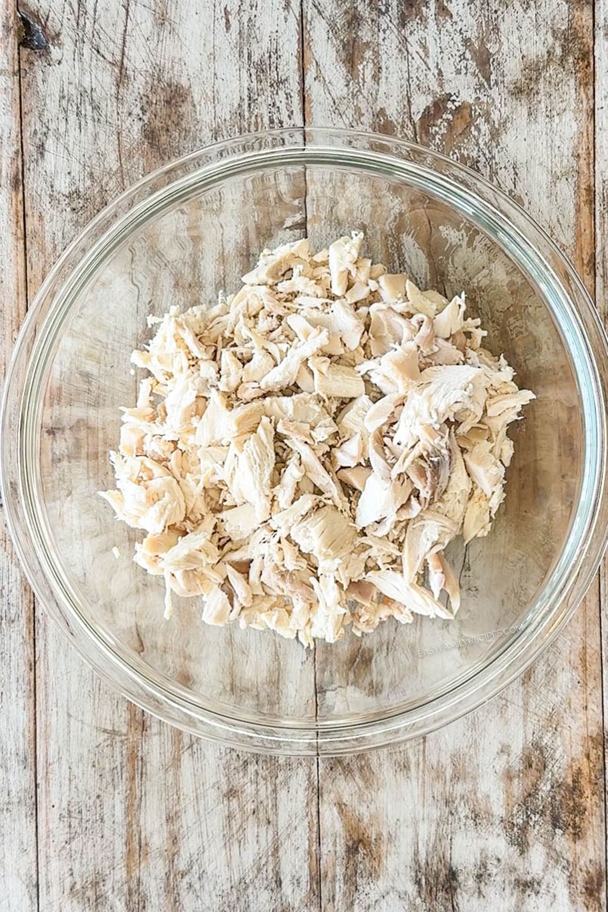shredded chicken in a glass bowl