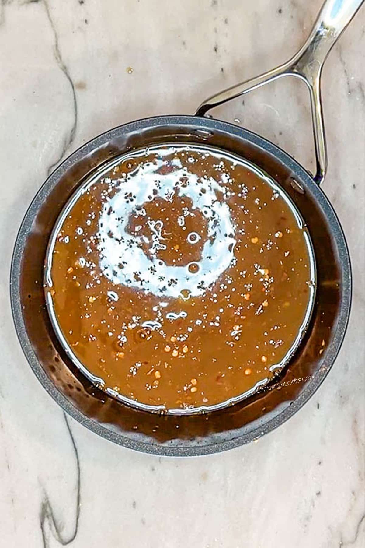 Orange chicken sauce in a saucepan.