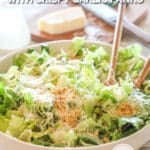 side view of a large salad bowl filled with caesar salad.