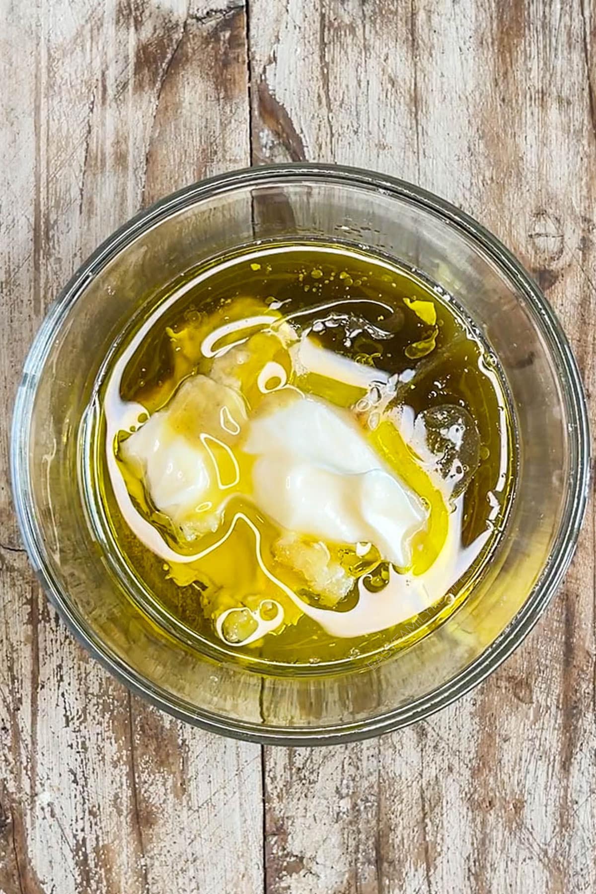 unmixed ingredients for caesar dressing in a bowl.