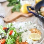Lemon Feta Chicken on a white plate with sides of rice and salad