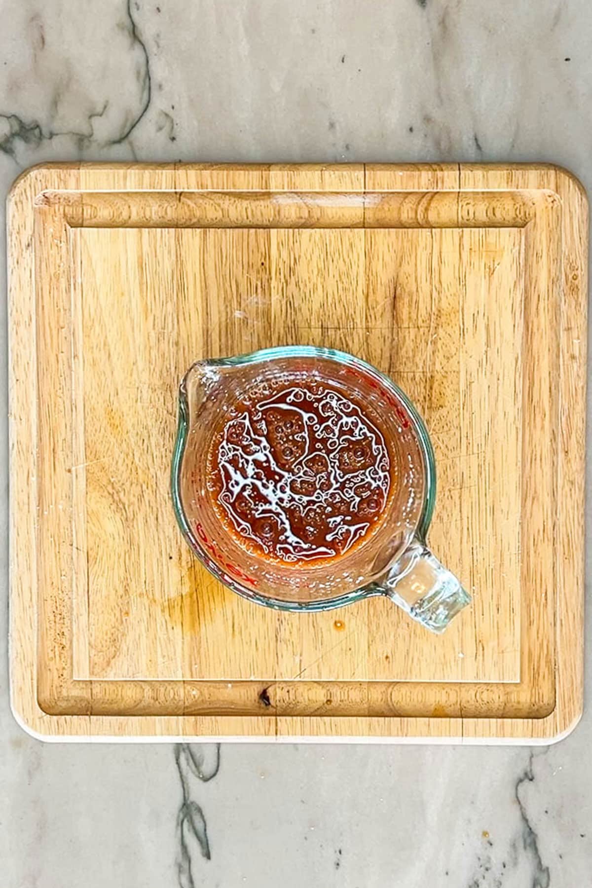 Sweet and sour sauce in a measuring cup.
