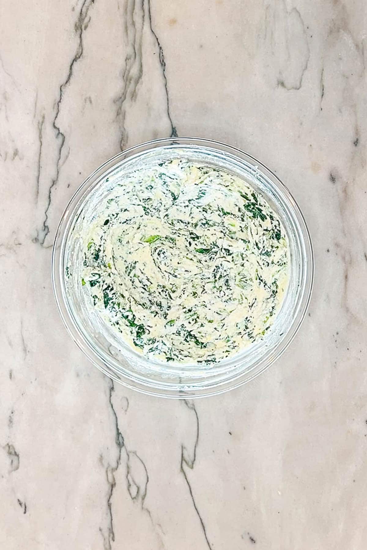 Overhead shot of the spinach ricotta mixture in a small bowl.