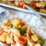 Sweet and sour chicken served with rice on a white plate.