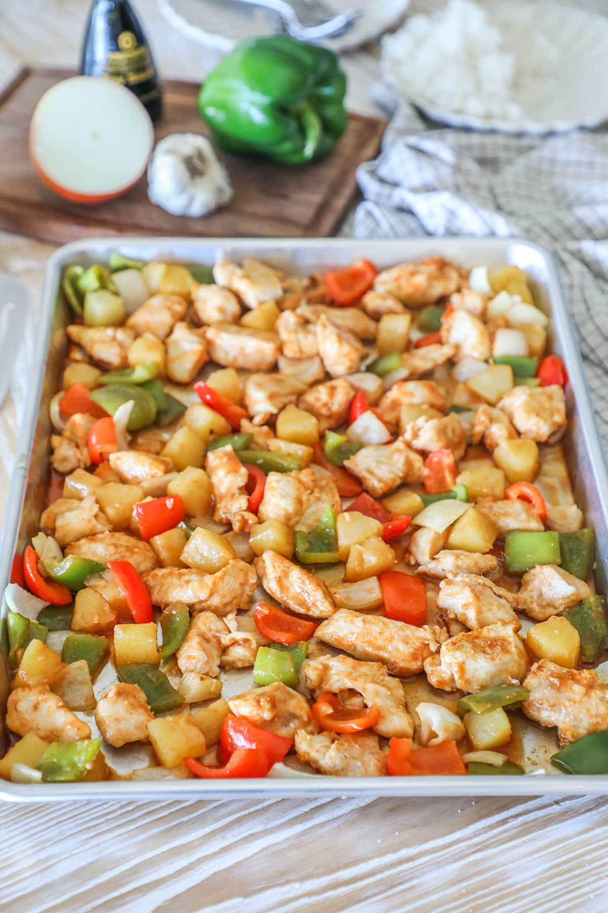 Side view of sheet pan sweet and sour chicken.