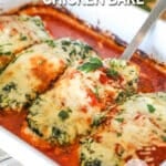 Spinach ricotta chicken bake with a spatula going into the baking dish to pick a piece of chicken up.