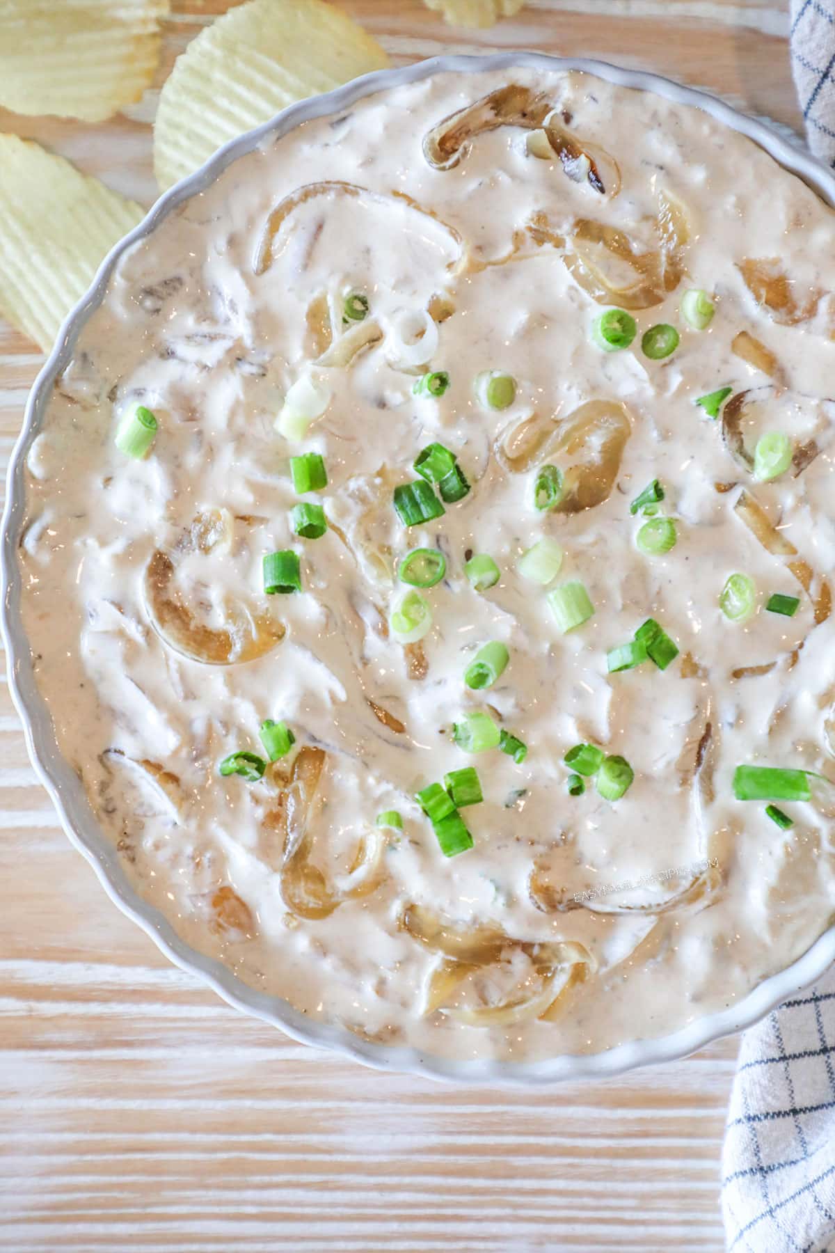 above image of onion dip in a shallow bowl.