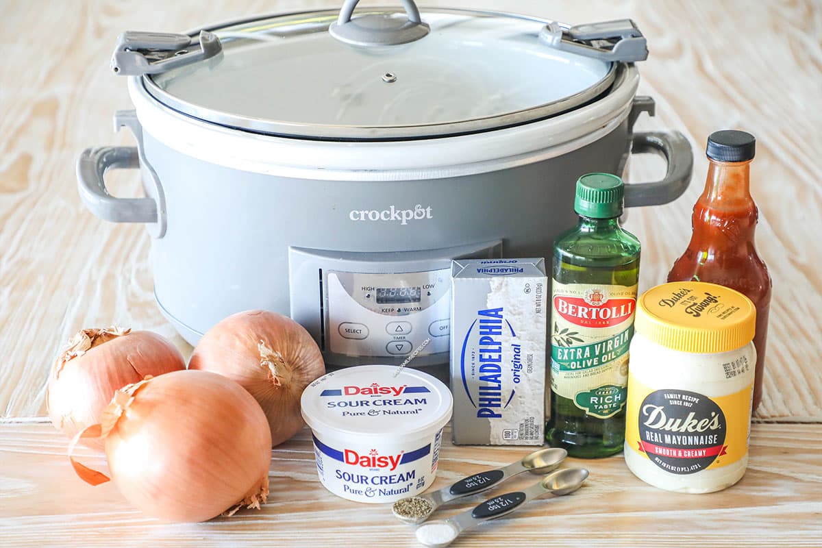 ingredients for onion dip next to a slow cooker.