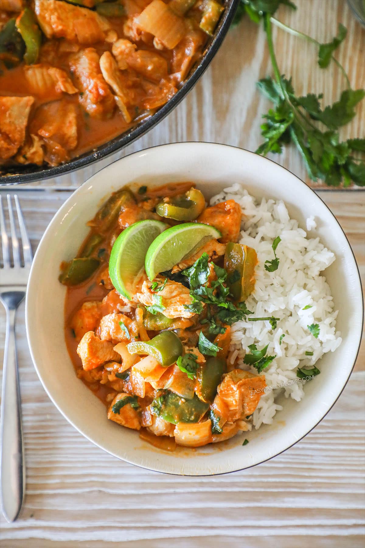 Overhead shot of one pan chicken curry served in a bowl with rice.