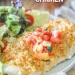 Piece of panko cheddar chicken on a plate with a side salad.