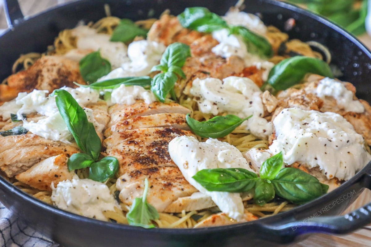 Brown butter spaghetti with chicken, basil and burrata in pan