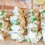 greek chicken gyro skewers on wooden board