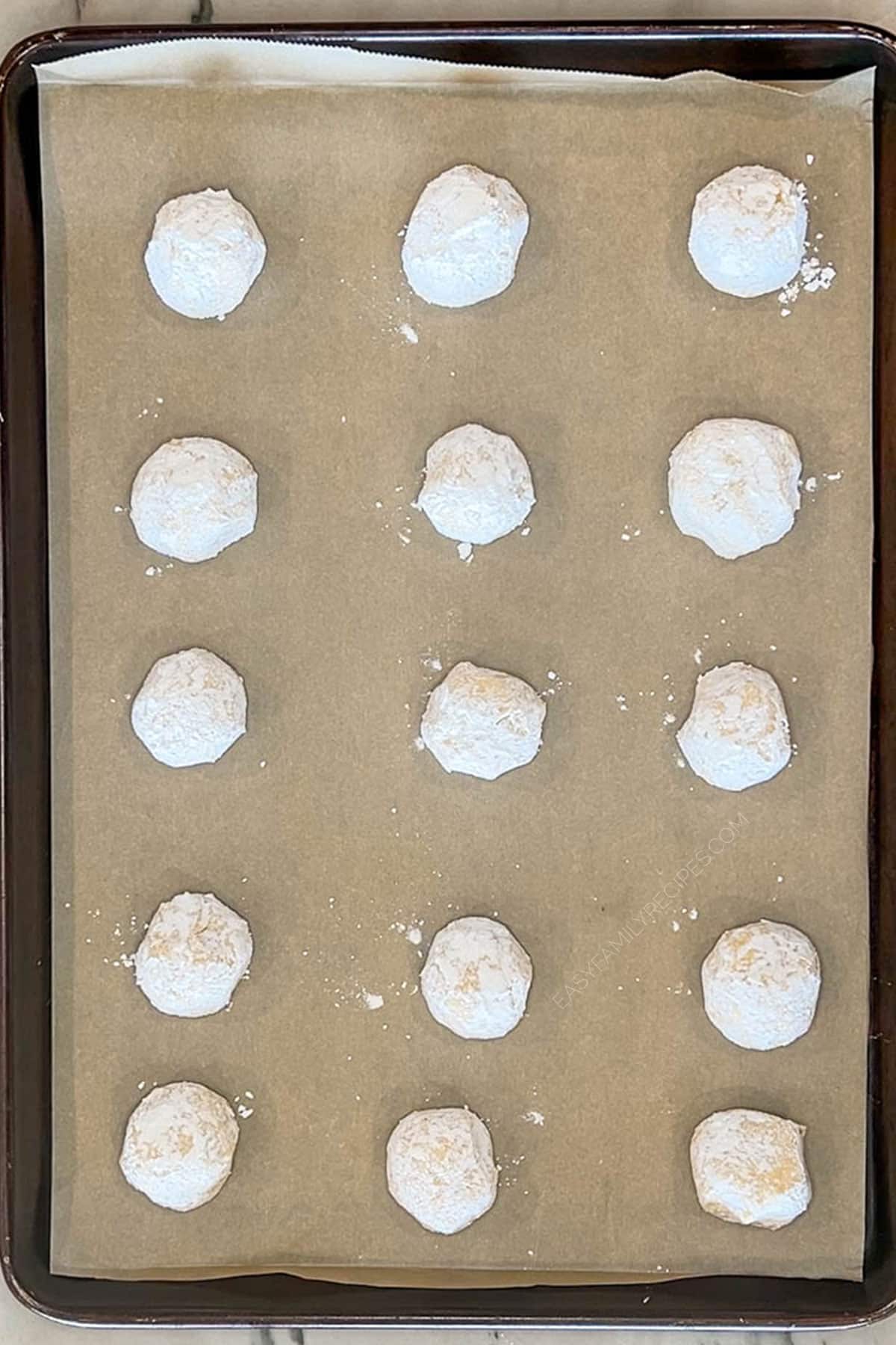 Cookie dough balls on baking sheet with parchment paper