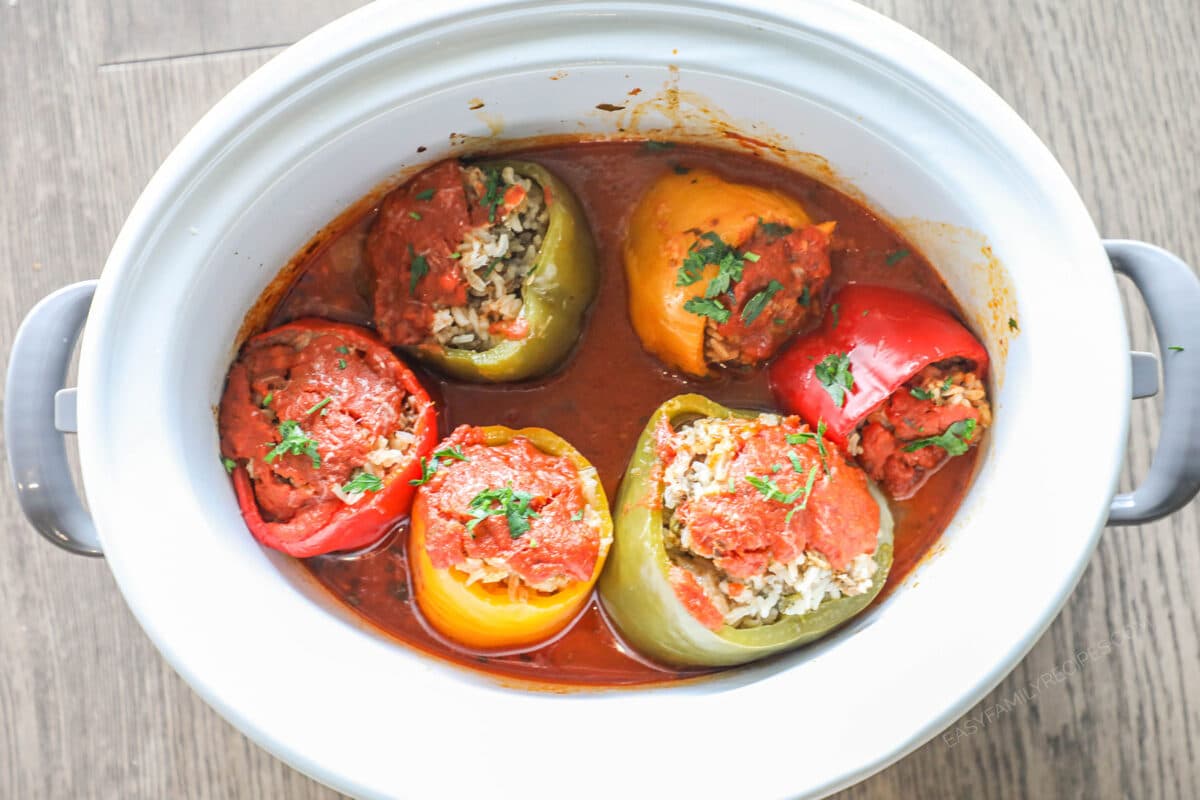 Cooked stuffed peppers in a white crock pot