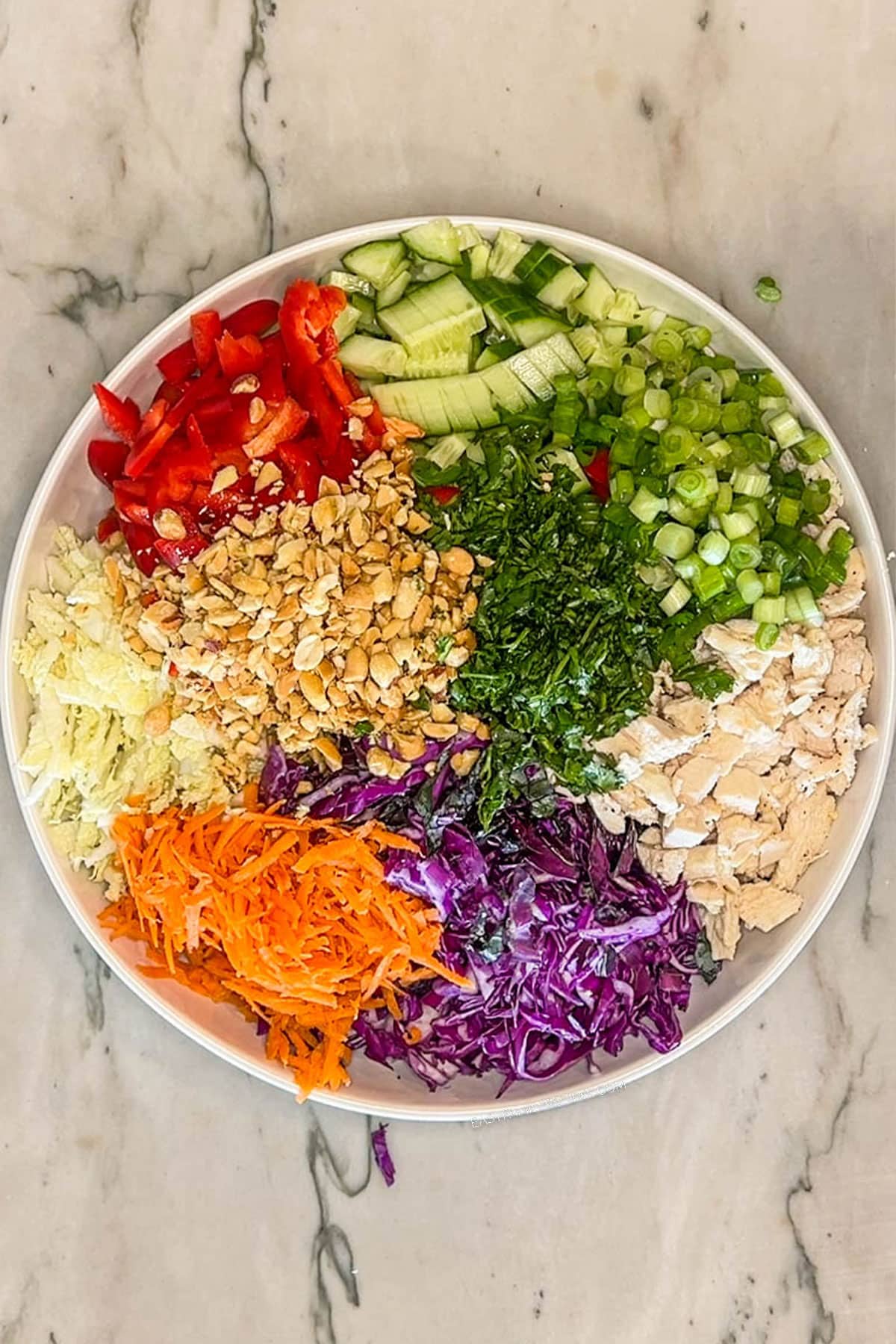 Add next ingredients: red bell pepper, shredded carrots, green onion and chopped peanuts