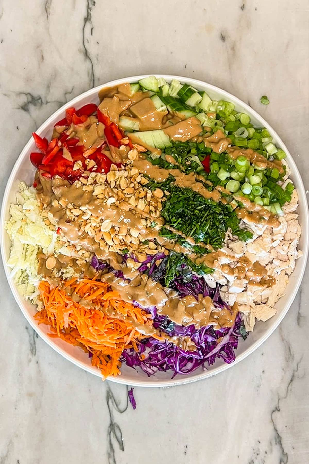 Next step- drizzle homemade peanut dressing on top of salad ingredients