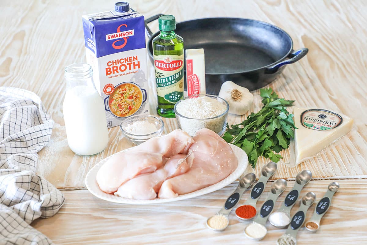 Ingredients for how to make Creamy Smothered Chicken and Rice- on a wooden background