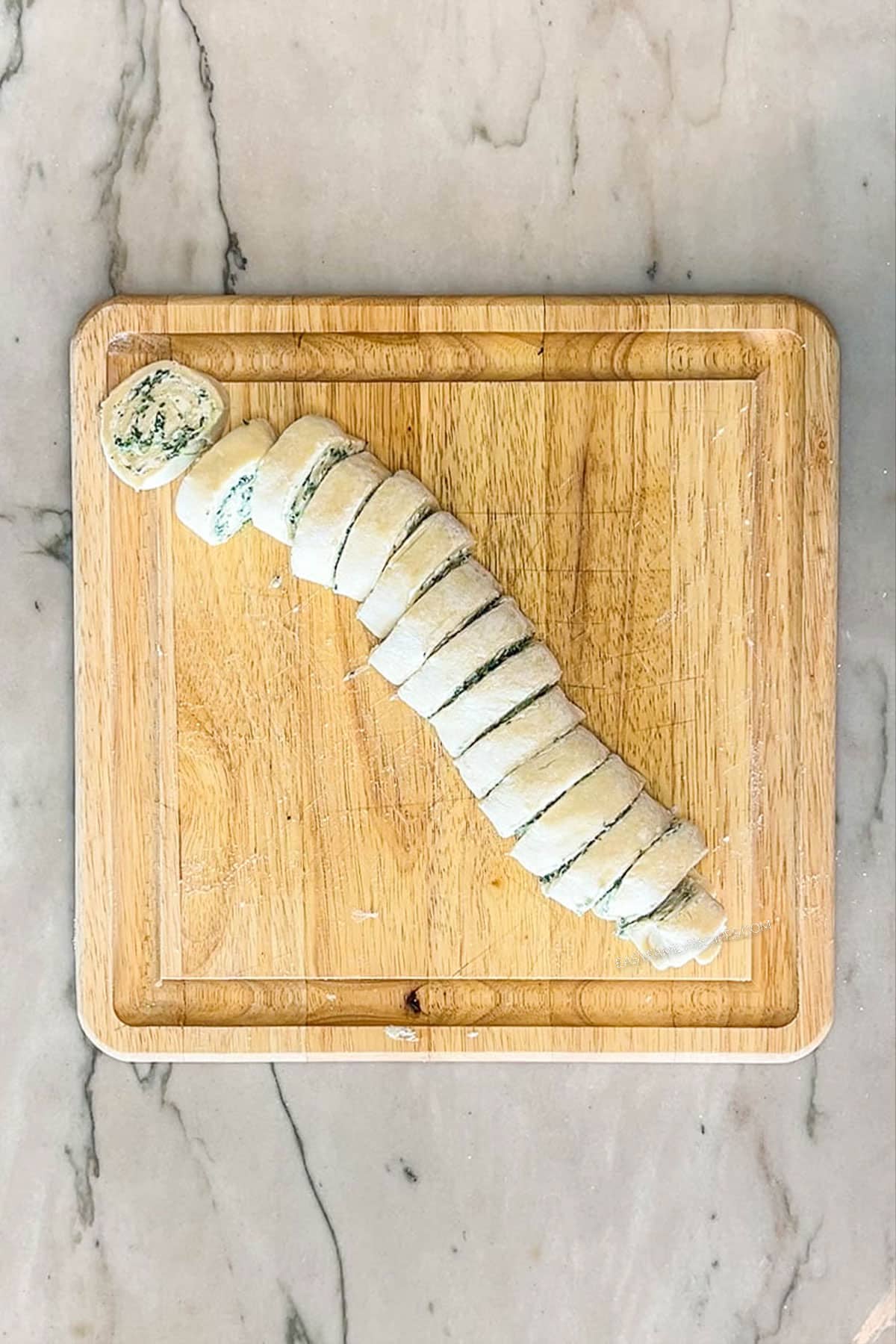 Rolled pastry cut into slices. On a wooden board.