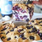 a slice of blueberry cake being lifted out of a baking dish.