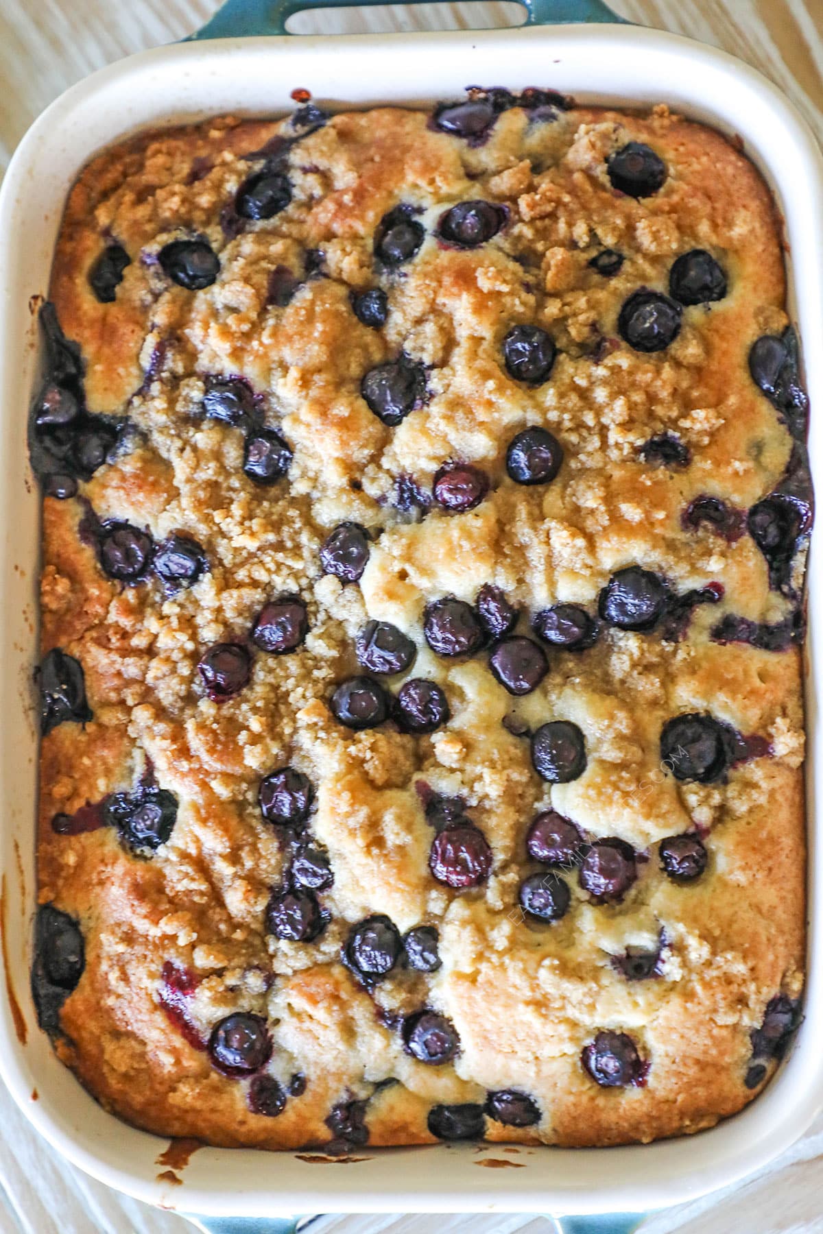 above image of blueberry breakfast cake in a baking dish.
