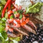 Close up of a carne asada bowl with toppings like salsa, beans and guacamole.