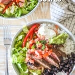 Overhead shot of two carne asada bowls with salsa, guacamole and beans.