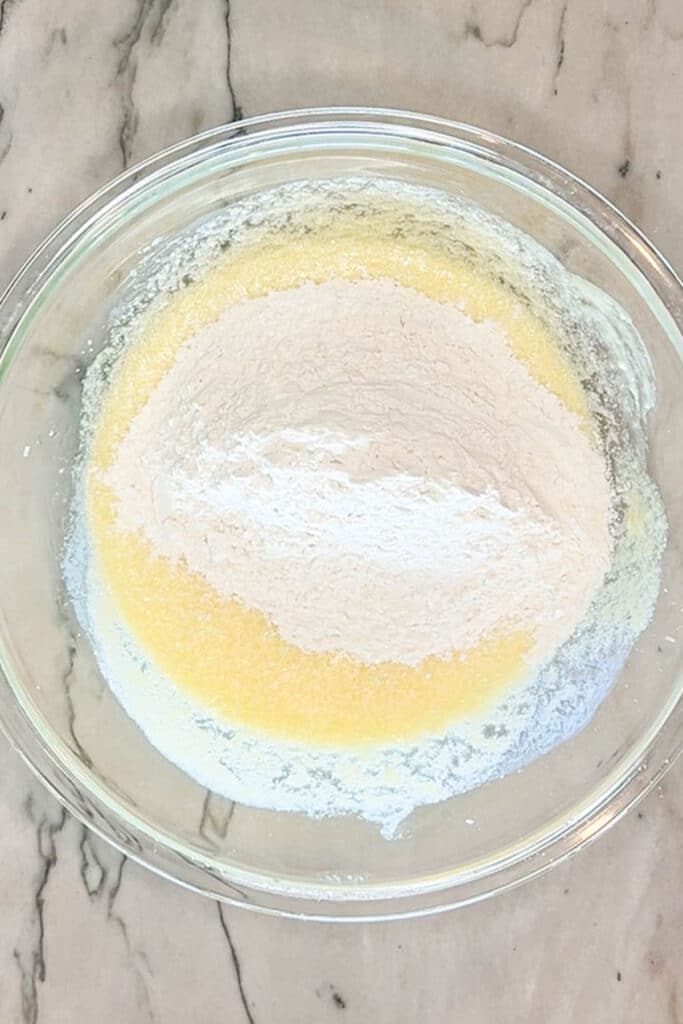 dry ingredients added to wet ingredients in a bowl.