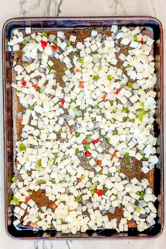 potatoes o'brien layered on a baking sheet.