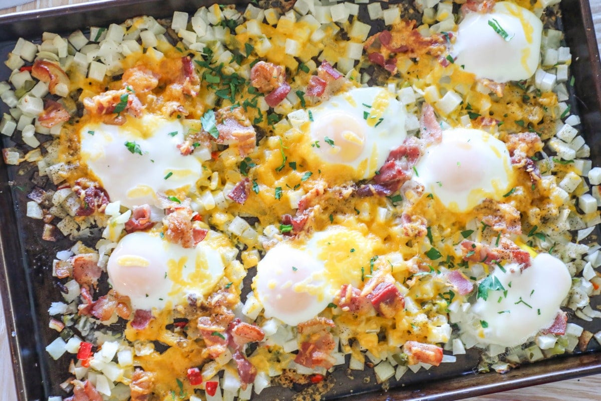 above image of sheet pan bacon egg breakfast has on a baking sheet.