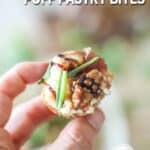 Close up of hand holding a single Goat Cheese and Fig Jam Puff Pastry Bite