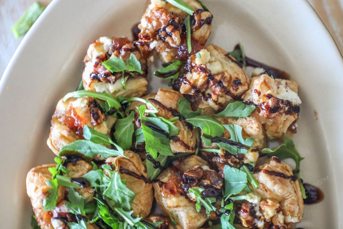 Goat Cheese and Fig Jam Puff Pastry Bites on white platter