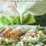 homemade dressing being drizzled over a salad.