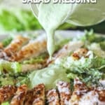 homemade dressing being drizzled over a salad.