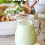 homemade green goddess dressing in a glass pitcher.