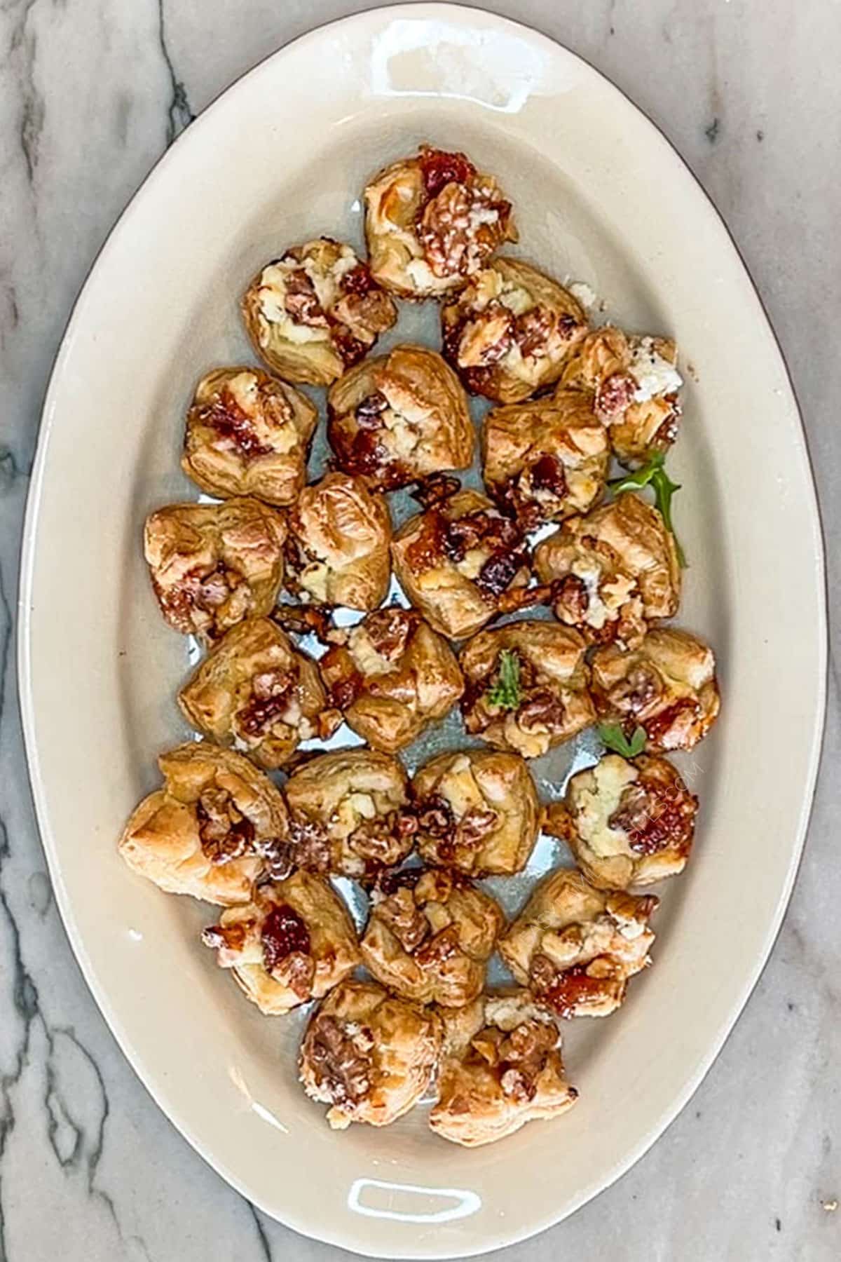 Step 3 for making Goat Cheese and Fig Jam Puff Pastry Bites. On a white dish and a marble background