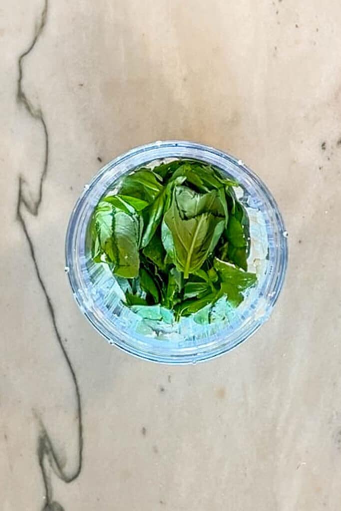 fresh greens added to a blender.