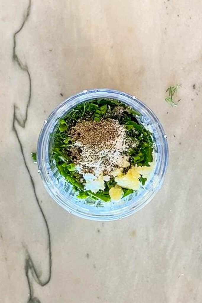 ingredients for green goddess salad dressing in a blender.
