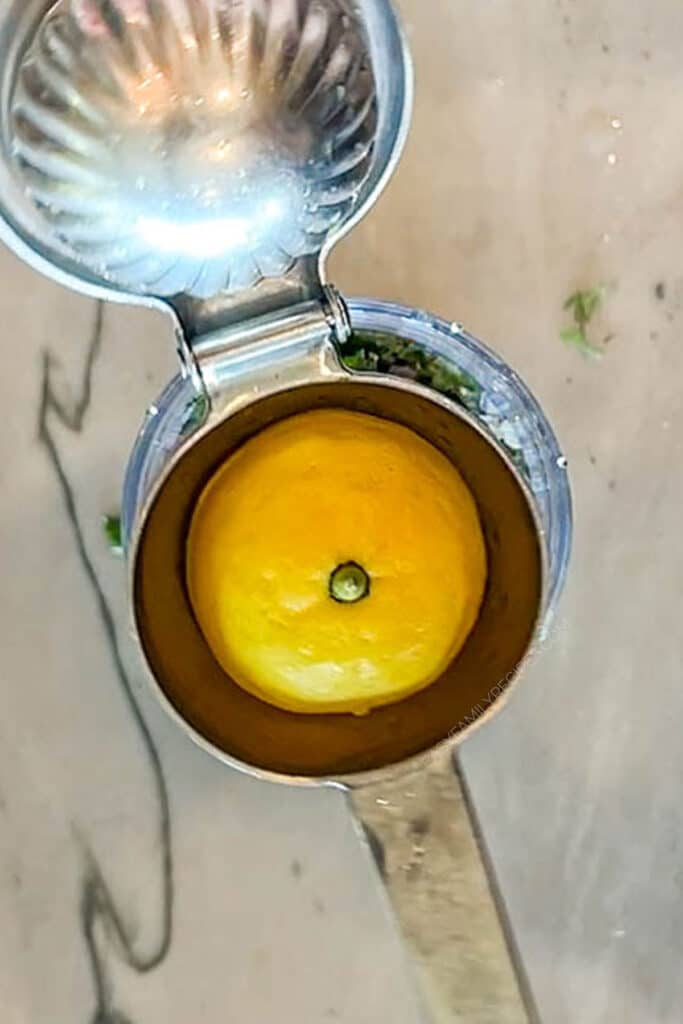 fresh lemon juice being squeezed.