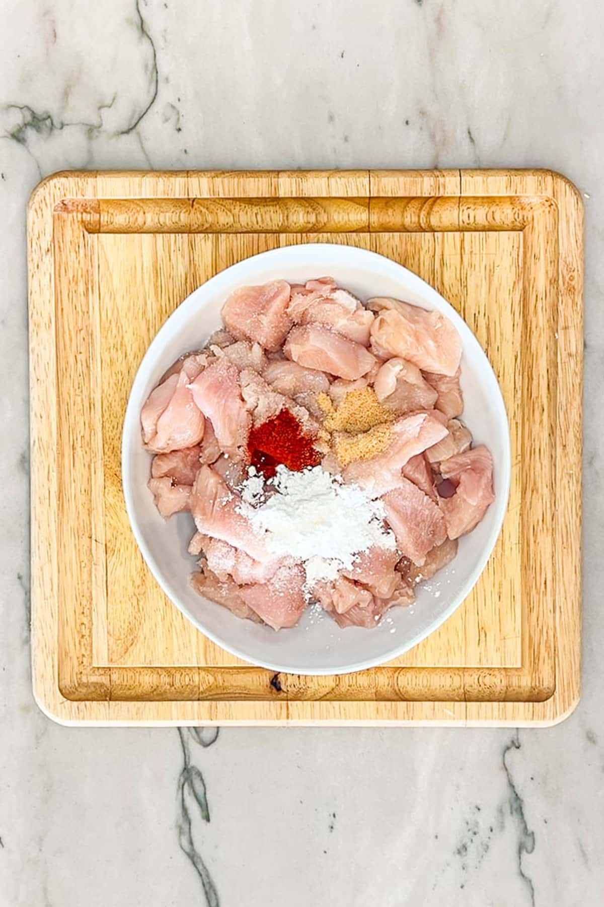 Diced chicken with spices and cornstarch on top.