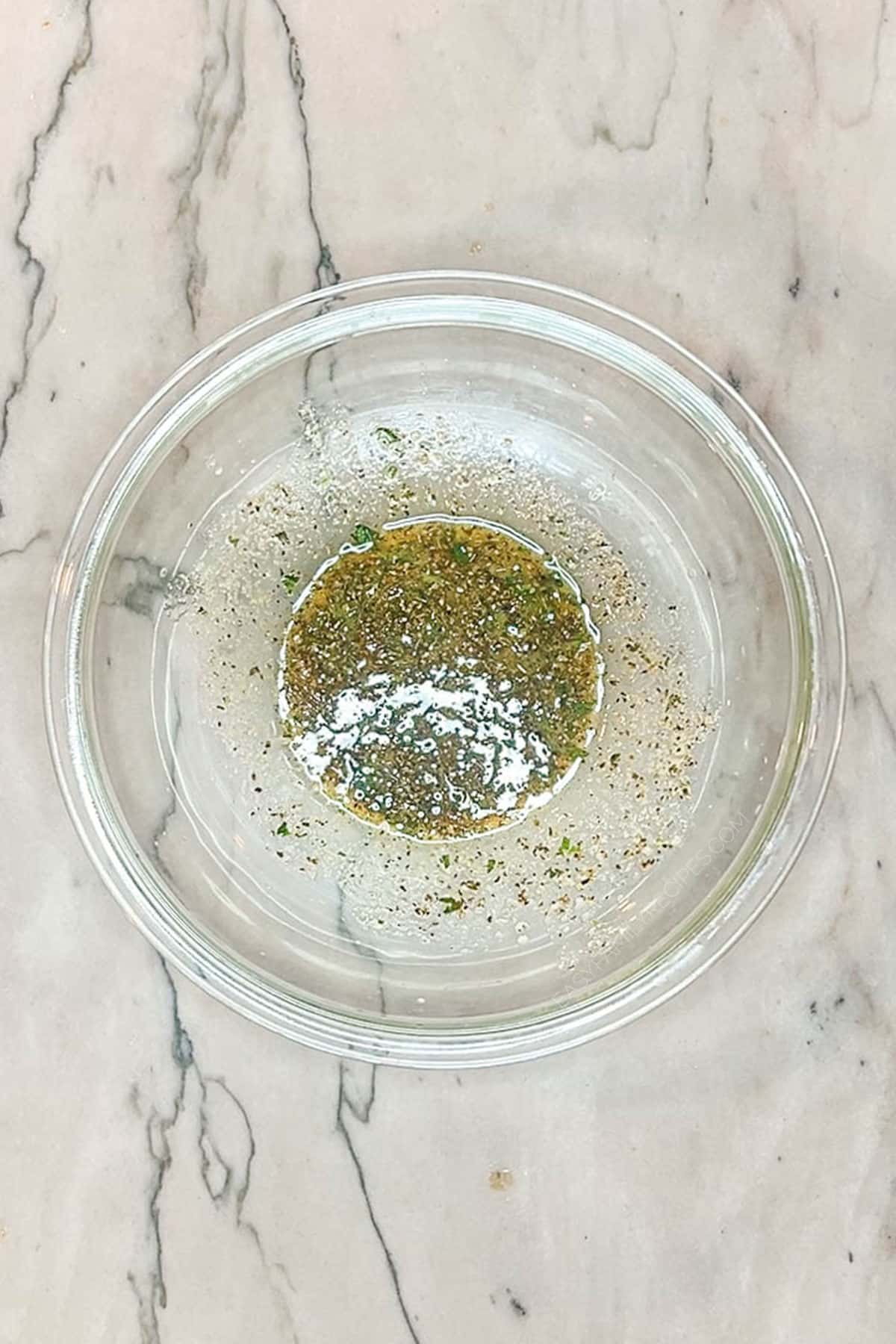 Mediterranean chicken marinade mixed together in a bowl.