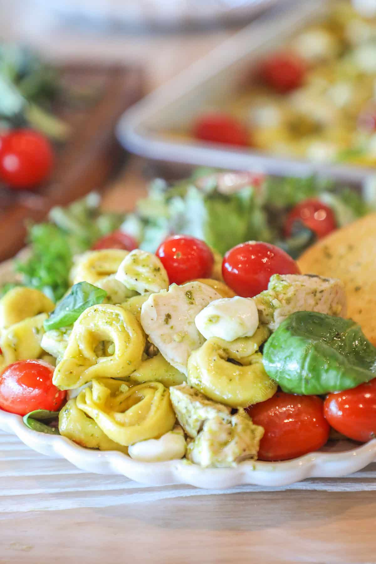 Side view of one pan caprese chicken and tortellini on a plate.